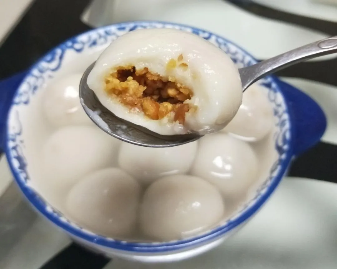 Traditional Chinese tangyuan glutinous rice balls with sweet peanut filling - a classic festive dessert